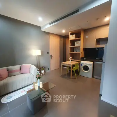 Modern living room with stylish furniture and integrated kitchen appliances