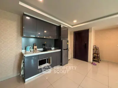 Modern kitchen with sleek cabinets and stainless steel appliances in a stylish apartment.