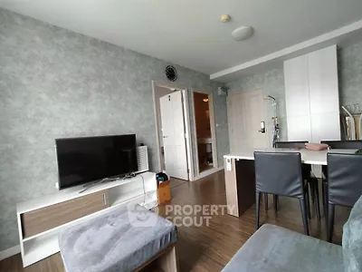 Modern living room with stylish furniture and TV, featuring a cozy atmosphere and elegant decor.