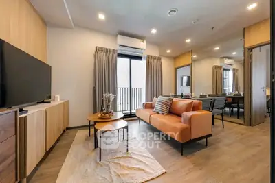 Modern living room with stylish furniture and balcony access in a contemporary apartment.