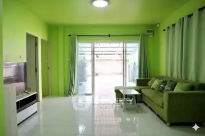Bright green living room with modern furniture and sliding glass doors to patio.