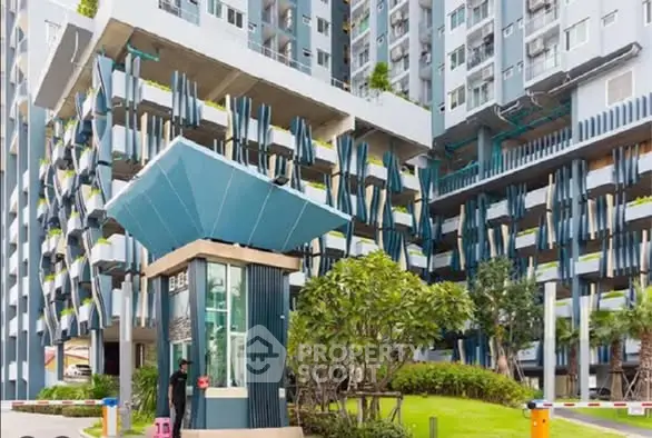 Modern residential building with unique architectural design and lush landscaping