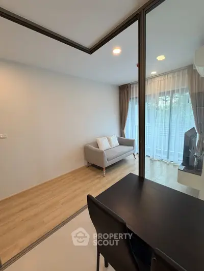 Modern living room with cozy sofa and large window for natural light