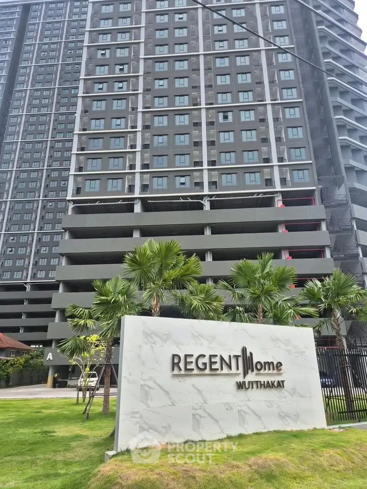 Modern high-rise condominium with lush landscaping at Regent Home Muttahkat.