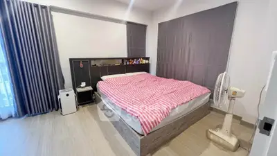Spacious bedroom with modern decor and natural light