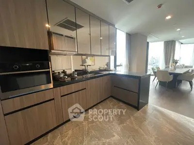 Modern kitchen with sleek cabinetry and dining area in luxury apartment
