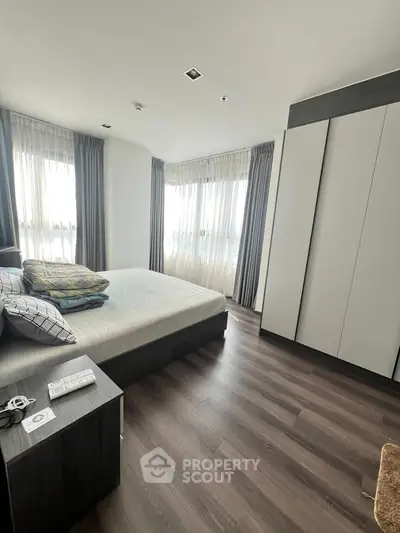 Modern bedroom with large windows and sleek wardrobe design