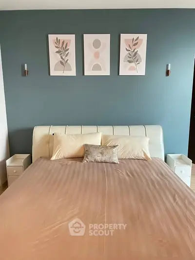 Elegant bedroom with stylish decor and modern artwork above bed