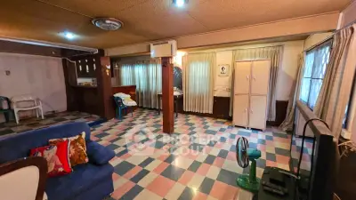 Spacious living room with retro checkered flooring and cozy seating area.