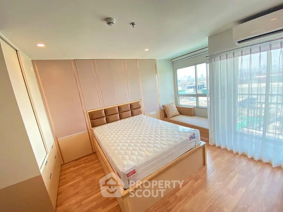 Spacious bedroom with large windows and modern design in a luxury apartment.