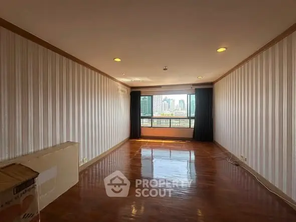 Spacious empty living room with city view and wooden flooring