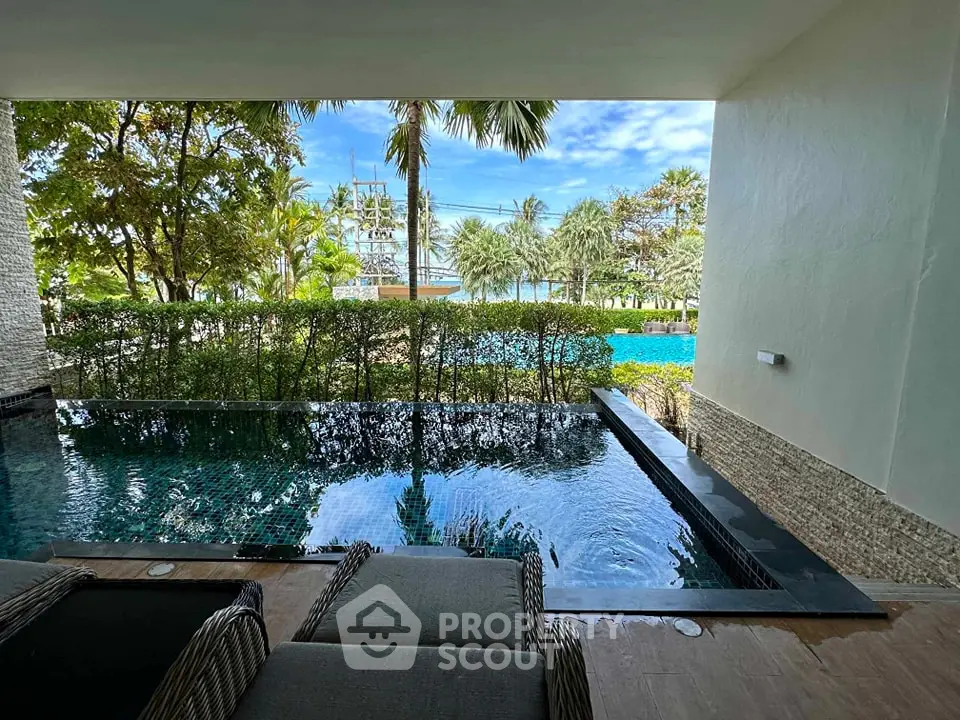 Luxurious poolside view with lush greenery and serene ambiance.