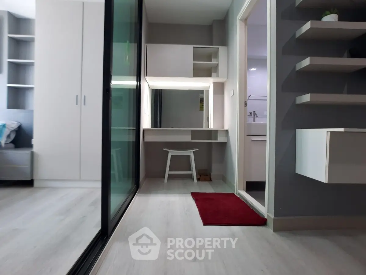 Modern apartment interior with sleek design and built-in storage solutions.
