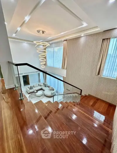 Luxurious modern staircase with elegant lighting and spacious living area view
