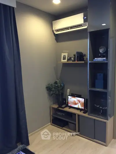 Modern living room corner with sleek shelving and air conditioning unit.
