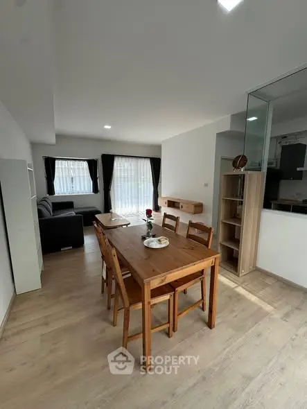 Spacious open-plan living and dining area with modern furnishings and natural light.