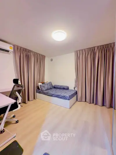 Modern bedroom with sleek design, featuring a cozy bed, stylish curtains, and a comfortable workspace.