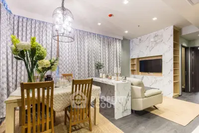 Elegant dining and living area with modern decor and marble accents