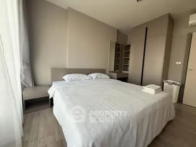Spacious modern bedroom with minimalist design and ample natural light.