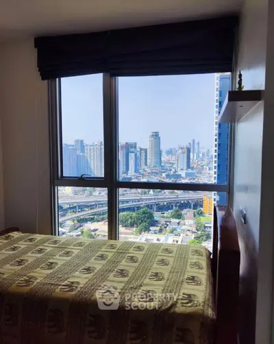 Stunning city view from a cozy bedroom with large windows and elegant decor.