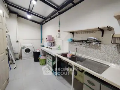 Functional kitchen with washing machine and ample storage space