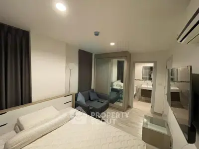 Modern bedroom with cozy lighting and stylish decor, featuring a comfortable bed and mirrored wardrobe.