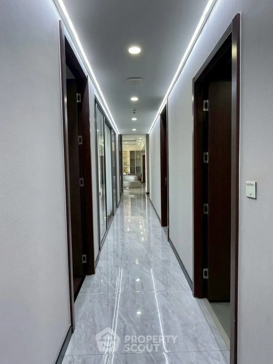 Sleek modern corridor with glossy marble flooring and recessed lighting