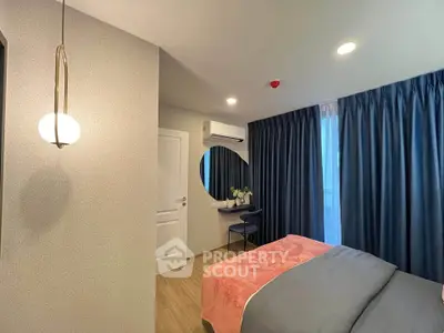 Modern bedroom with stylish decor, featuring a cozy bed, elegant lighting, and a sleek vanity area.
