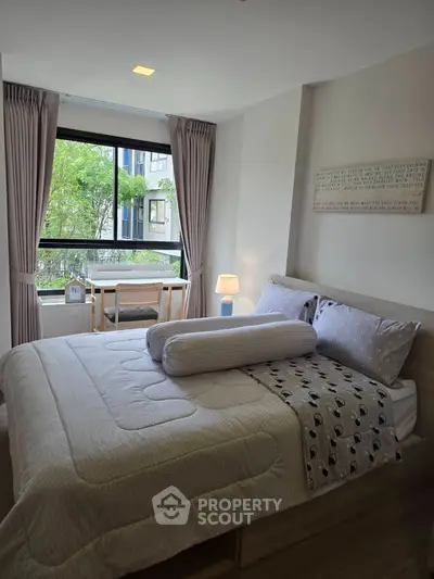 Cozy bedroom with large window and modern decor