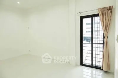 Bright empty room with large window and curtain, ideal for customization.