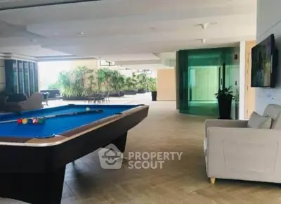 Luxurious rooftop with pool table and seating area, perfect for entertainment and relaxation.