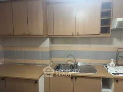 Cozy kitchen with wooden cabinets and modern sink in a stylish apartment.