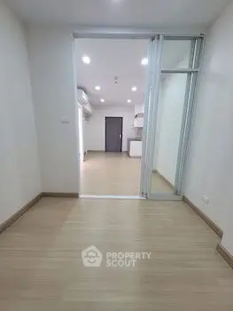 Spacious modern apartment interior with sliding glass doors and wooden flooring