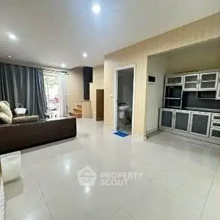 Spacious open-plan living room with modern kitchen and sleek design.