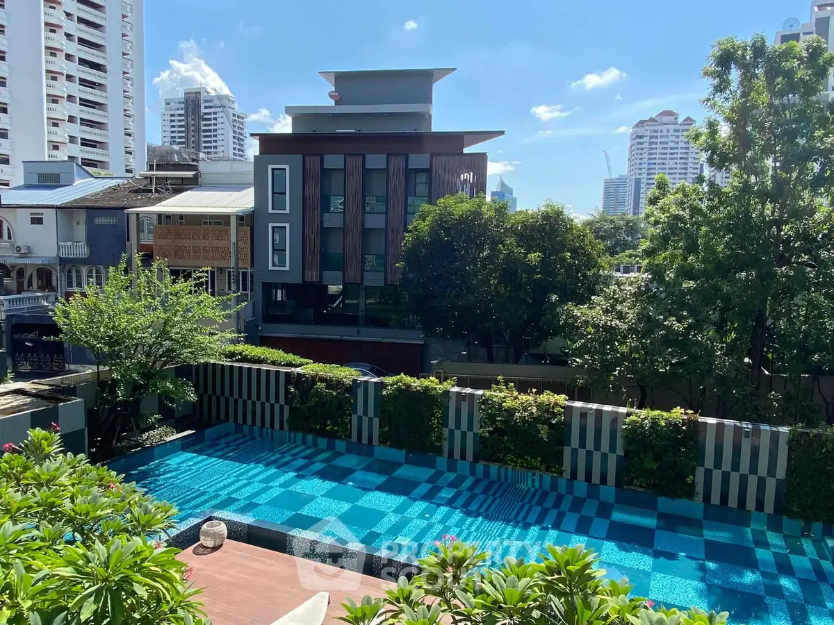 Luxurious urban pool with cityscape view, perfect for relaxation and leisure in a modern residential complex.