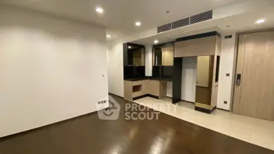 Modern apartment interior with sleek kitchen and wooden flooring