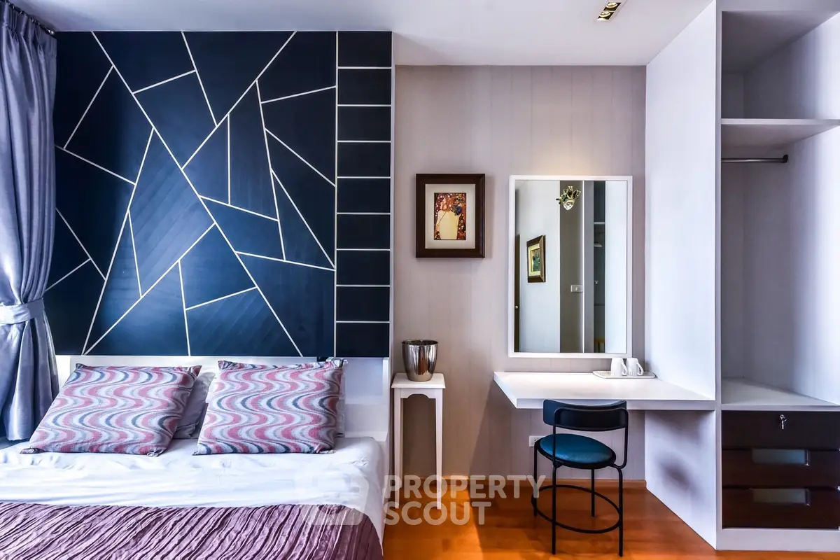 Stylish modern bedroom with geometric accent wall and cozy decor