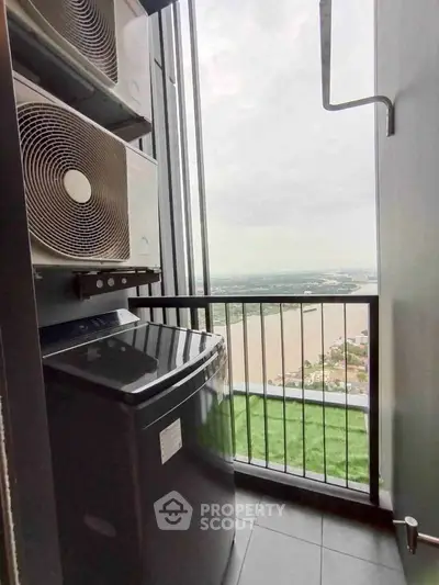 High-rise apartment balcony with washing machine and stunning river view.