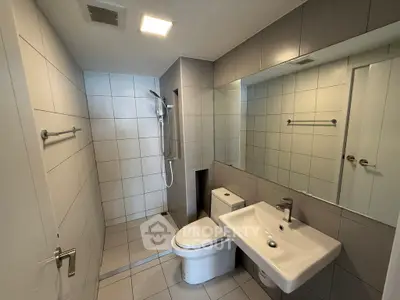 Modern bathroom with sleek fixtures and spacious shower area