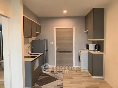Modern kitchen with sleek cabinetry and integrated appliances in a stylish apartment.
