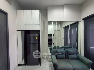Modern living room with sleek furniture and mirrored wall design