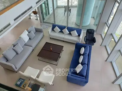Luxurious high-rise living room with modern furniture and stunning city views.