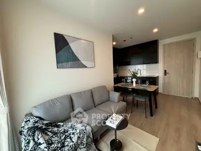 Modern living room with cozy sofa and dining area in open layout apartment.