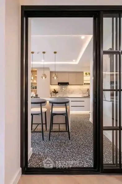 Modern kitchen with sleek design, featuring an open layout and stylish lighting, perfect for contemporary living.