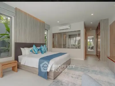 Luxurious modern bedroom with elegant decor and large windows
