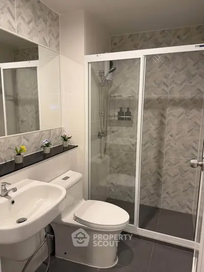 Modern bathroom with glass shower and stylish tiles