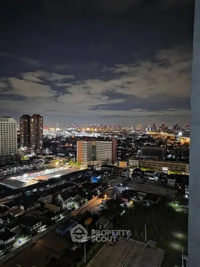 Stunning cityscape view from high-rise apartment at night, showcasing vibrant urban lights and skyline.