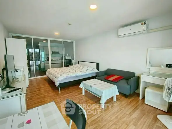 Spacious studio apartment with modern furnishings and wooden flooring