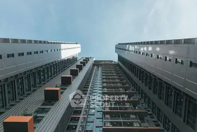 Stunning architectural view of modern high-rise building with sleek design and sky backdrop.