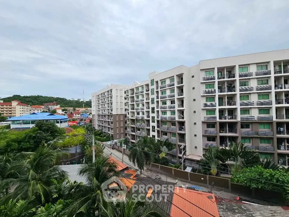 Modern apartment building with lush greenery and vibrant neighborhood view.